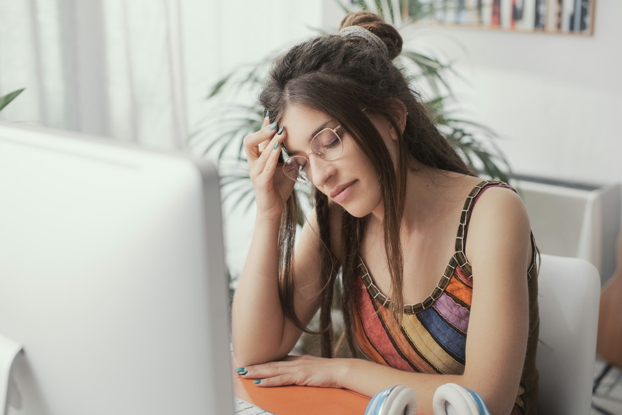 Tired young woman with headache